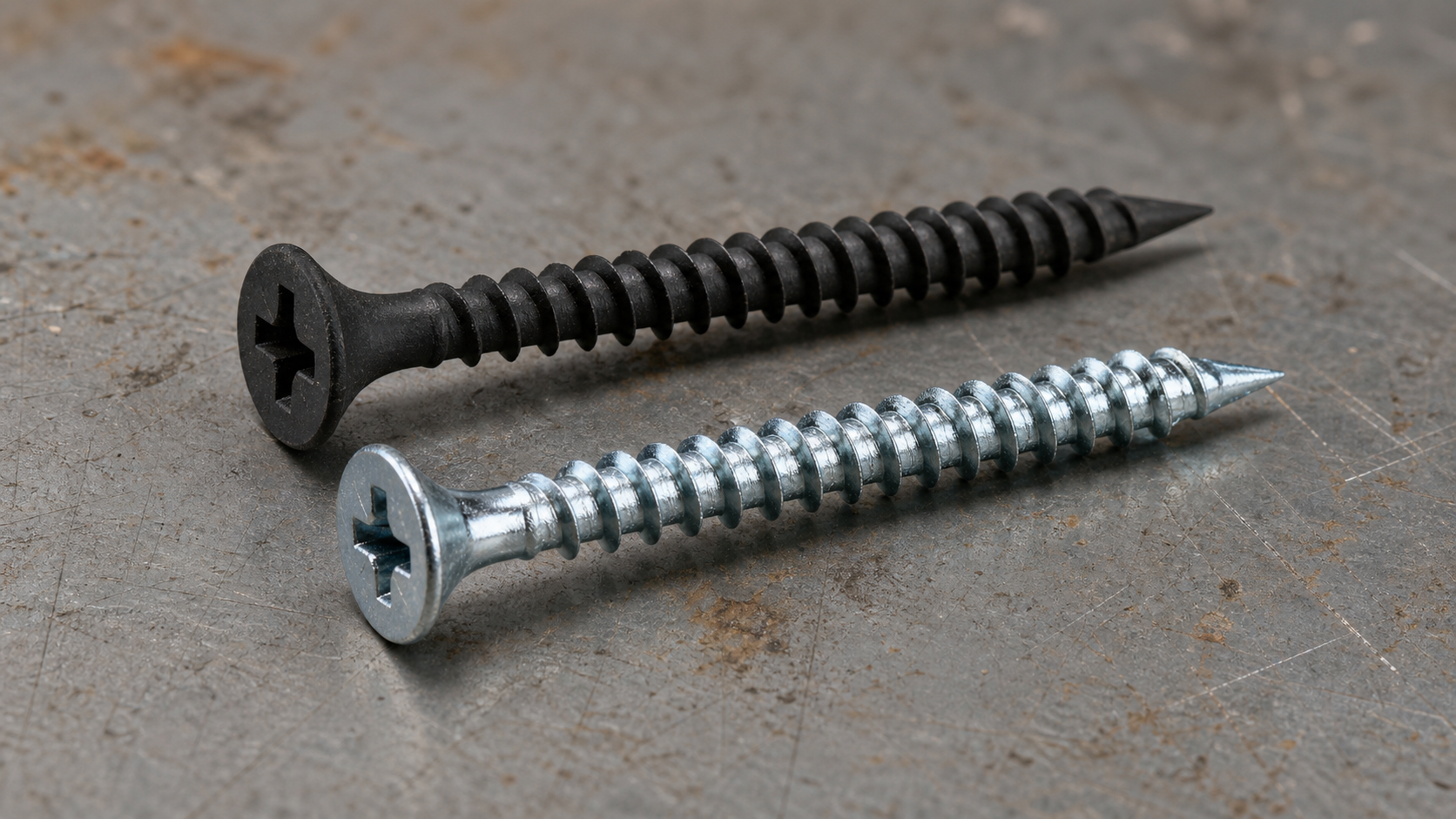 Side-by-side comparison of a black phosphate drywall screw and a galvanized drywall screw, showing the matte dark finish vers