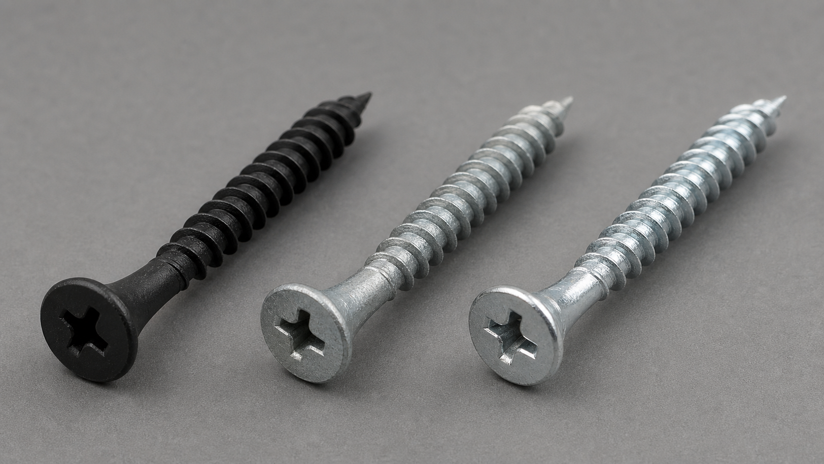 Comparison of three drywall screw finishes: matte black phosphate, silver galvanized zinc, and bright electro-zinc plated.